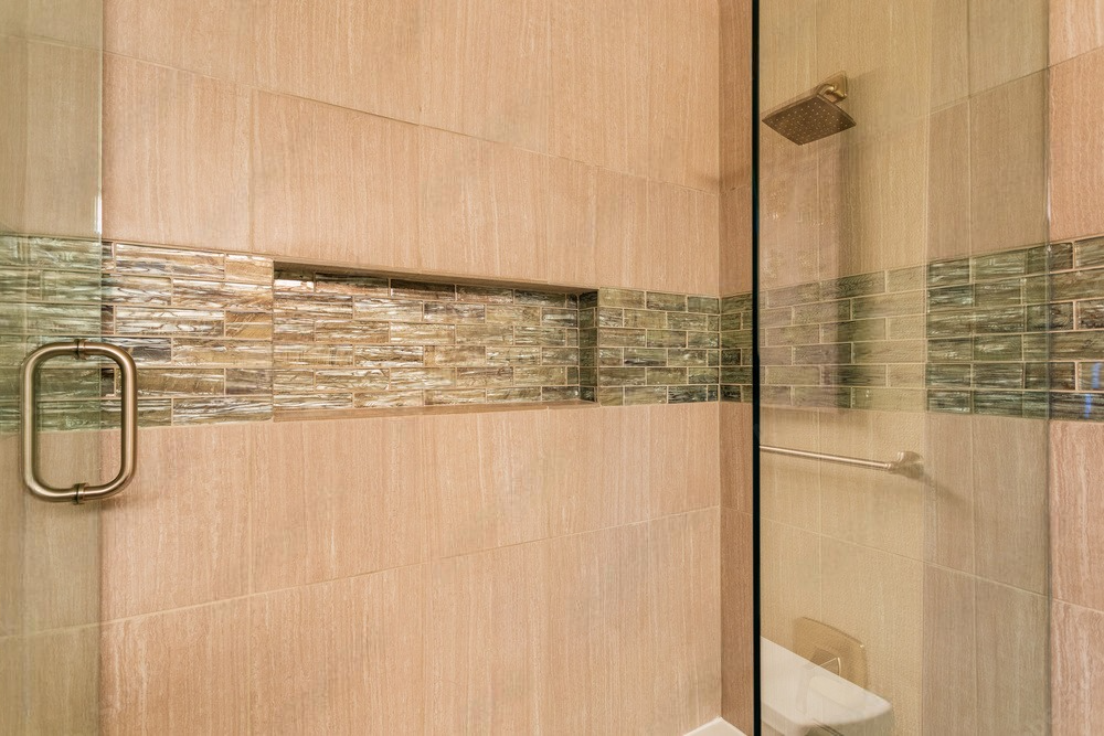 a bathroom with a walk in shower and a toilet .