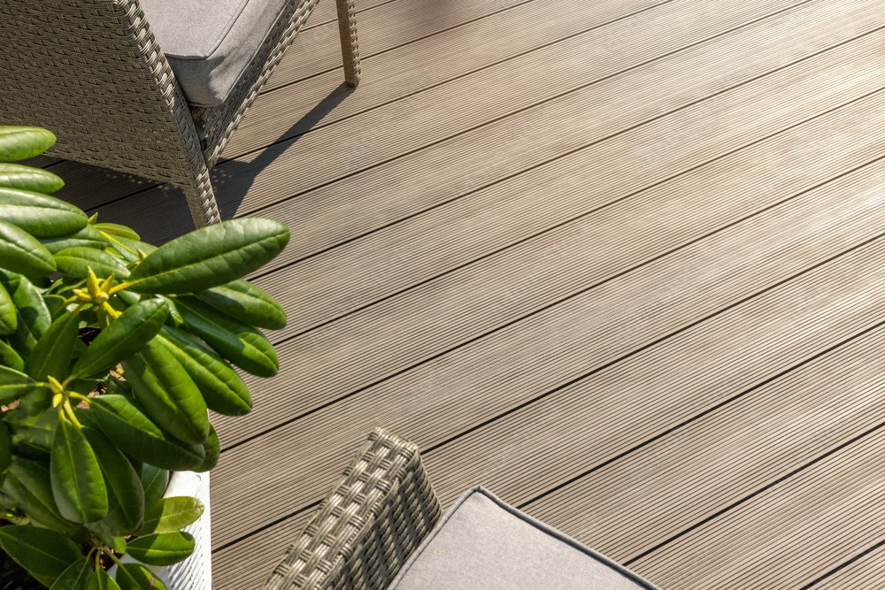 a wooden deck with a chair and a plant on it .