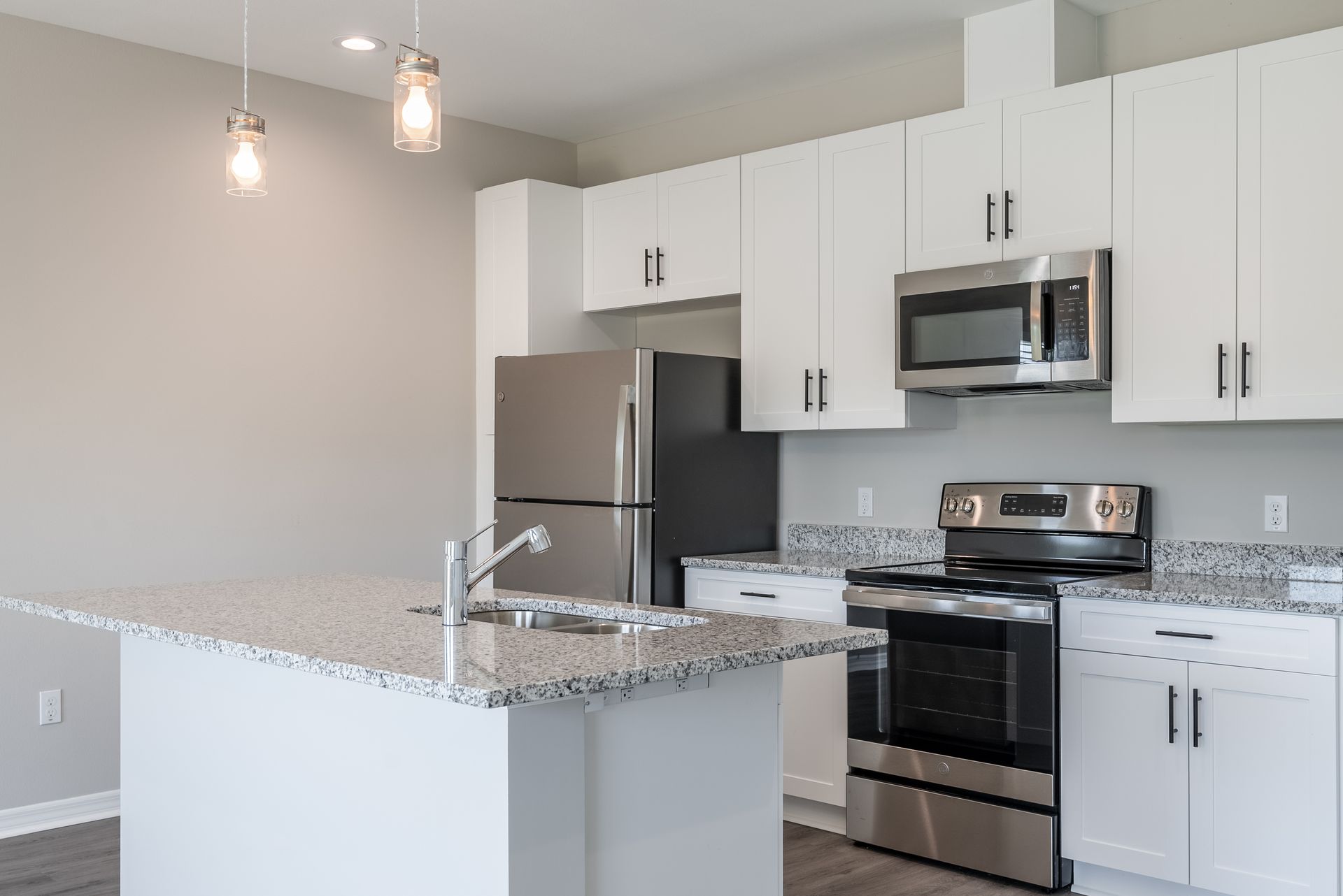 a kitchen with stainless steel appliances and granite counter tops