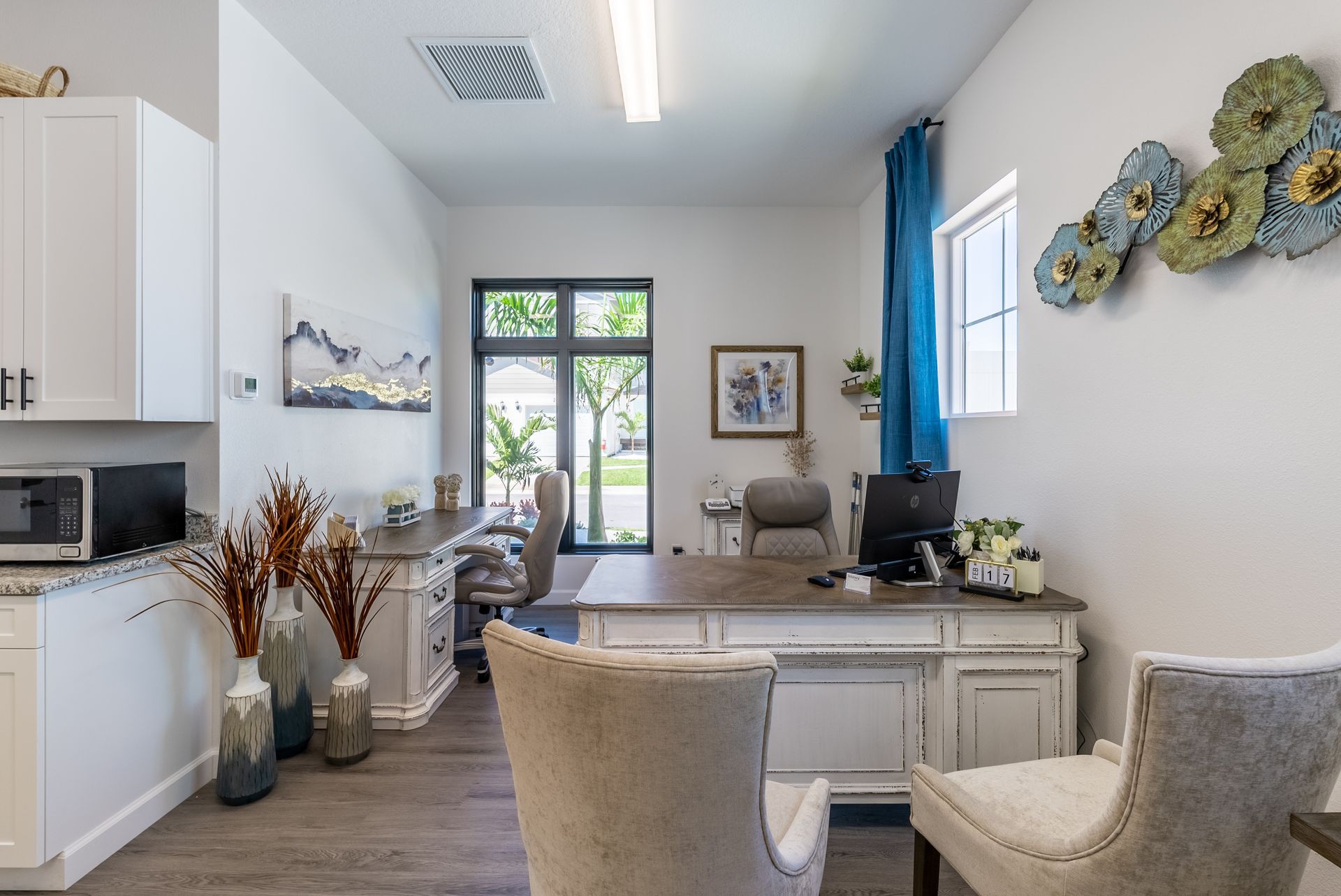 a room with a desk and chairs in it