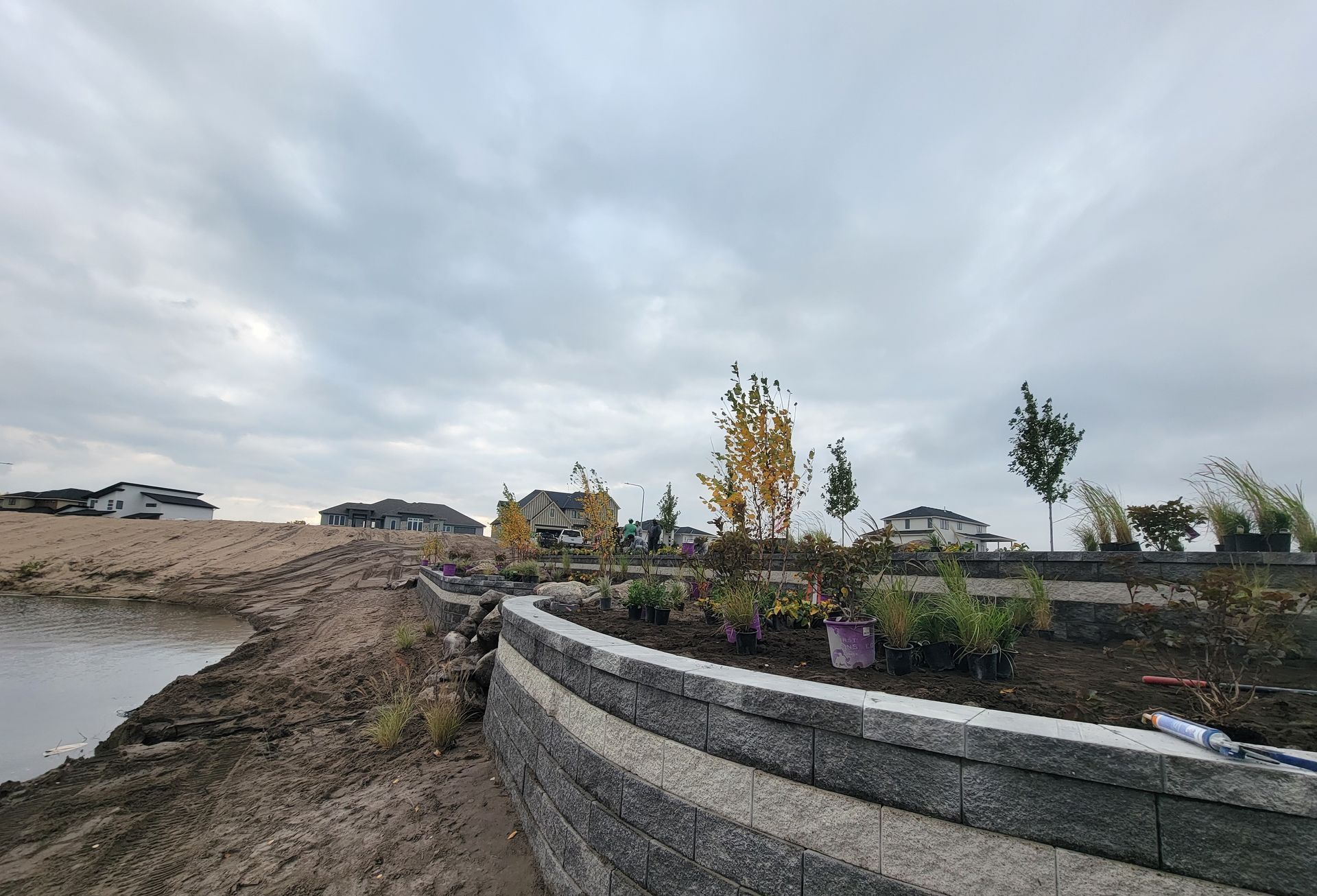 A retaining wall is being built next to a body of water.