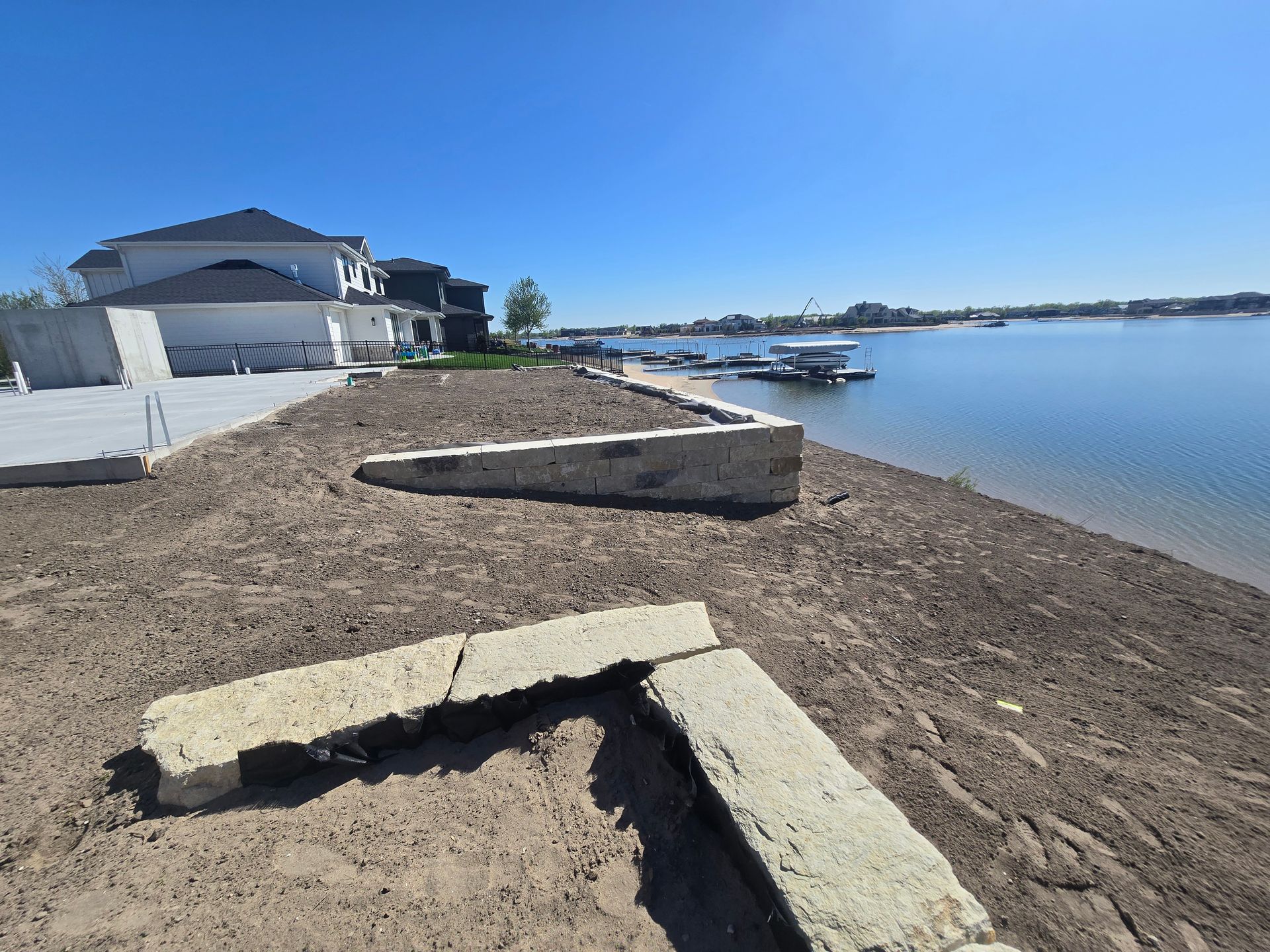 A house is sitting on the shore of a lake.