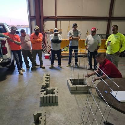 A group of men are standing around a table in a building.