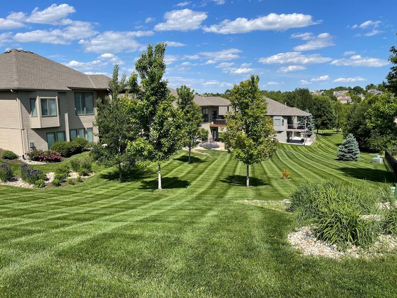 A large house with a lush green lawn in front of it.