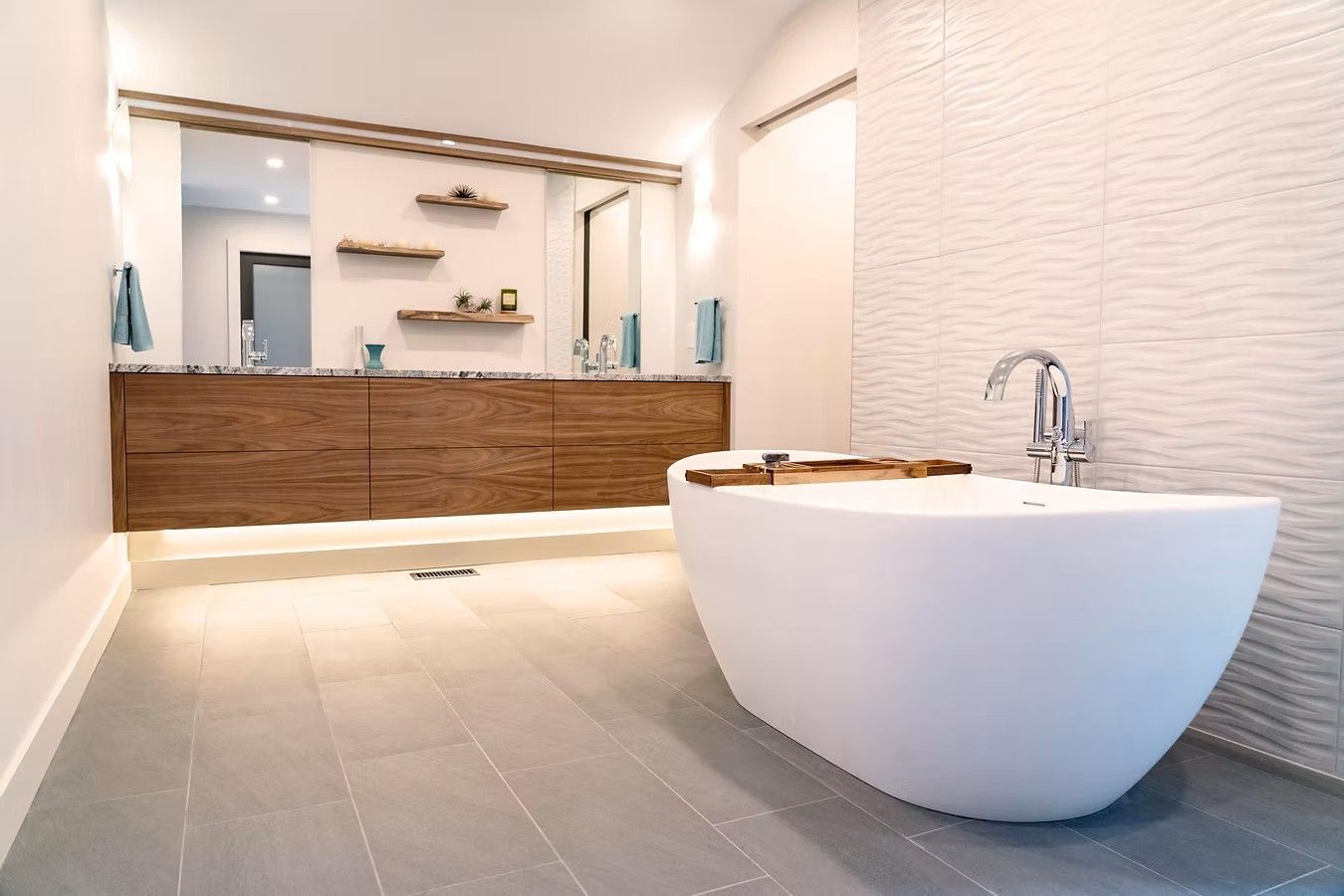 Modern bathroom with a white freestanding tub and a wooden vanity.