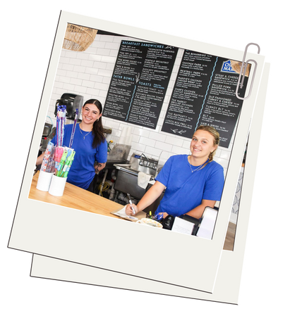 Two staff members standing behind the counter.