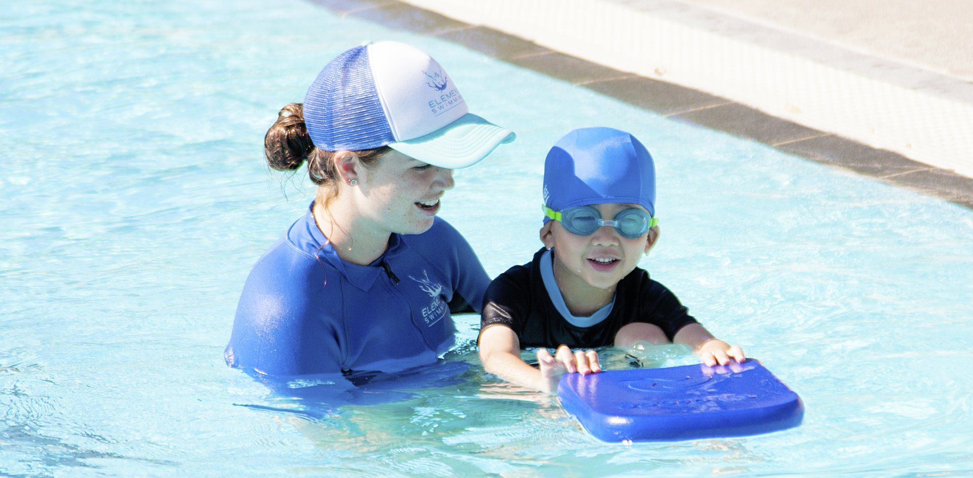 Swim instructor teaching student