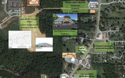 Aerial site map with labeled buildings, roads, green areas, and highlighted campus features.