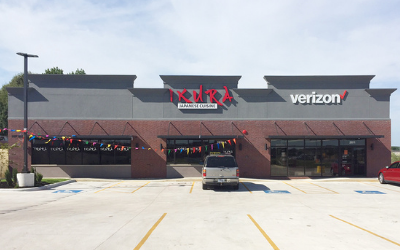 Shopping center storefront with Verizon and a Mexican restaurant, seen from a parking lot.