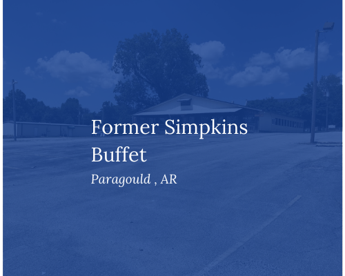 Blue-tinted sign reading “Former Simpkins Buffet” in Paragould, AR, over a roadside scene