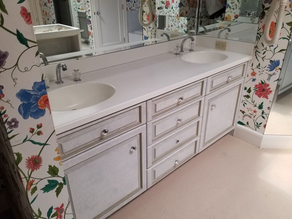 A bathroom with two sinks and a mirror.