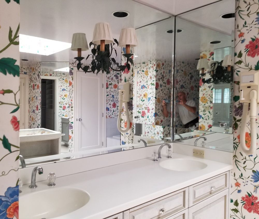 A bathroom with two sinks and a large mirror