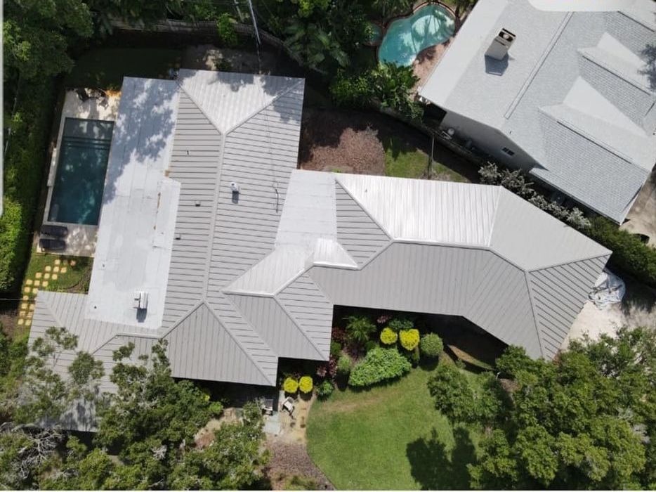 An aerial view of a house with a swimming pool
