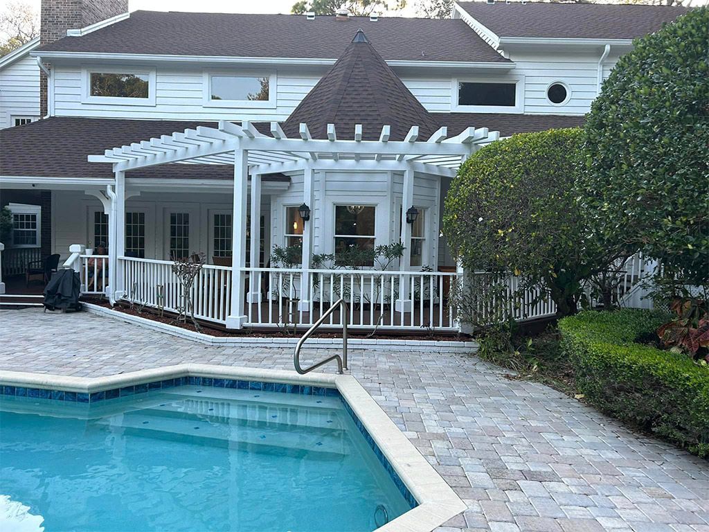 A large white house with a swimming pool in front of it