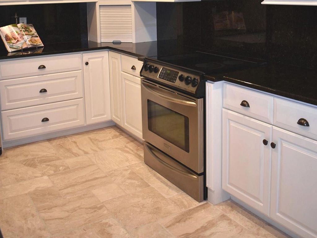 A kitchen with stainless steel appliances and white cabinets