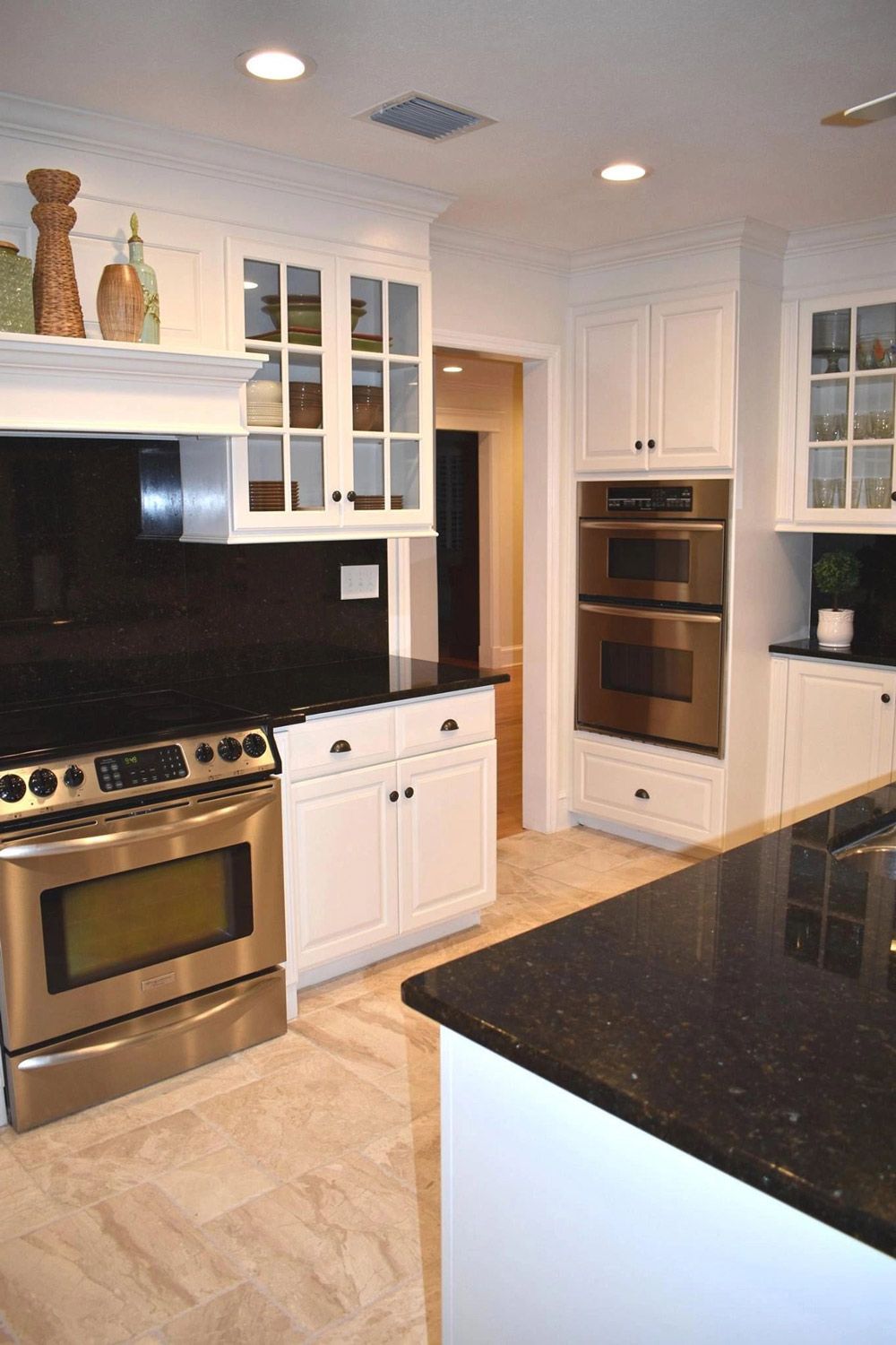 A kitchen with stainless steel appliances and white cabinets