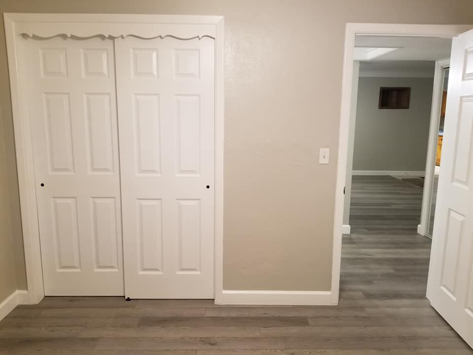 A room with a closet and a door that is open