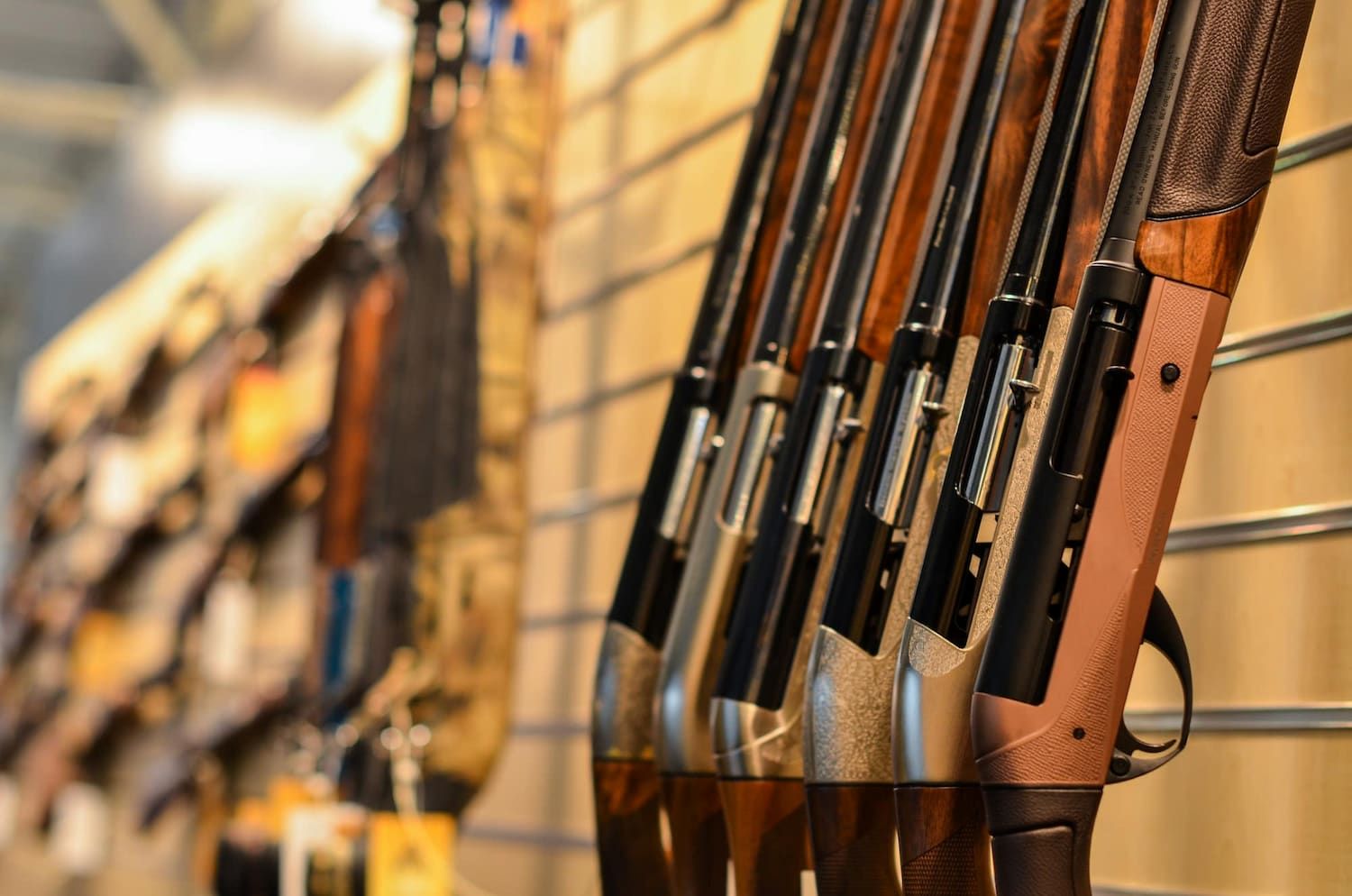 A Row of Shotguns Hanging on a Wall in a Store — Mackay Shooters Supplies in Longreach, QLD