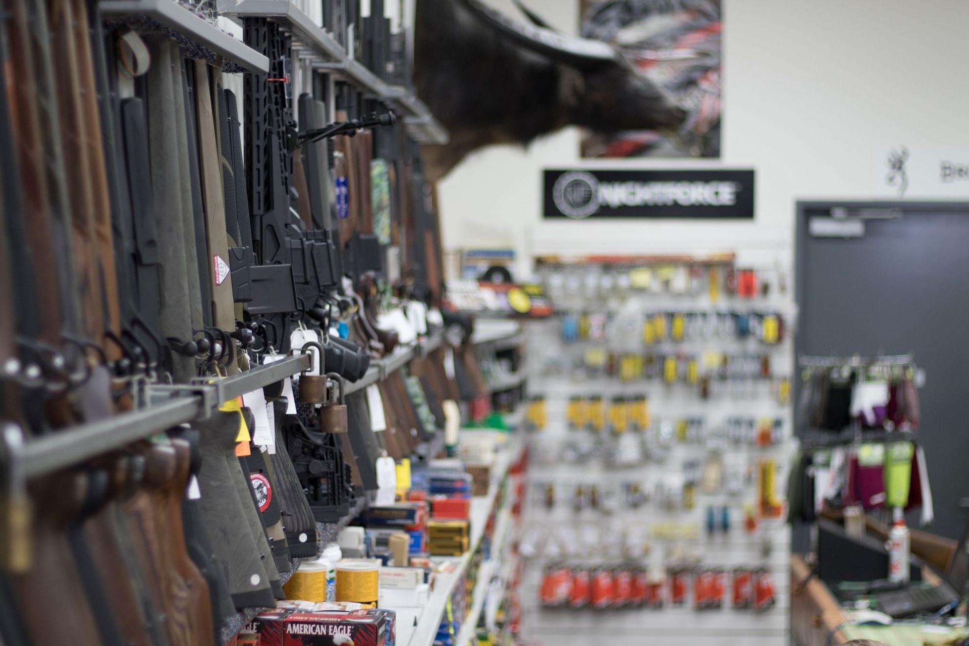 A Row of Shotguns Hanging on a Wall in a Store — Mackay Shooters Supplies in Paget, QLD