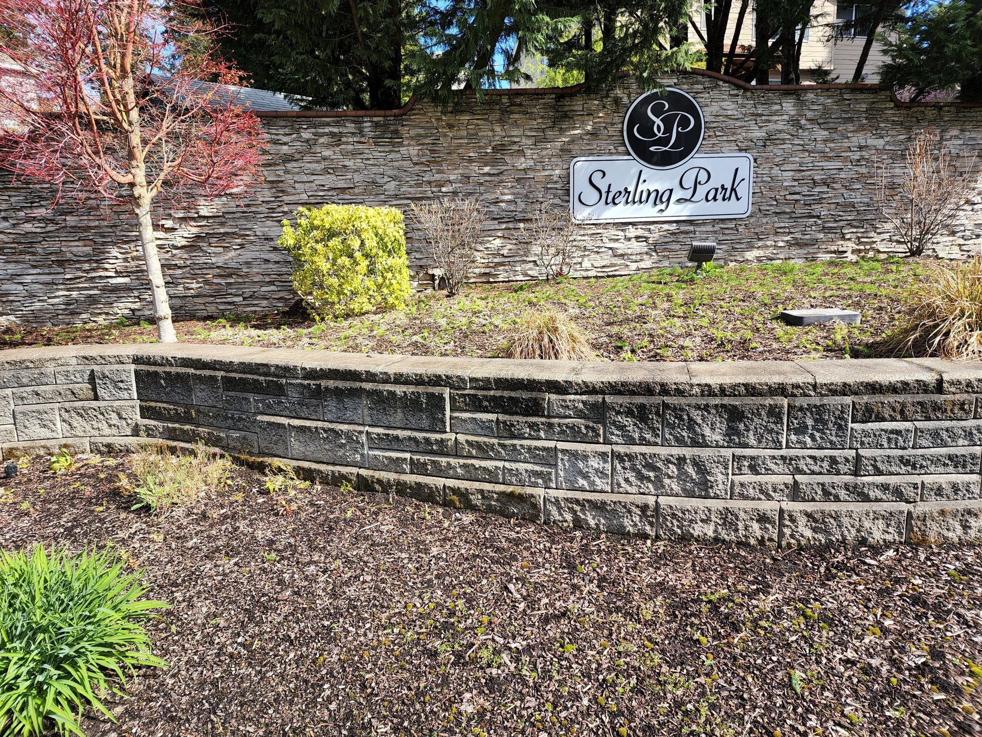Hot water pressure washing removing mold and mildew from commercial Retaining Walls