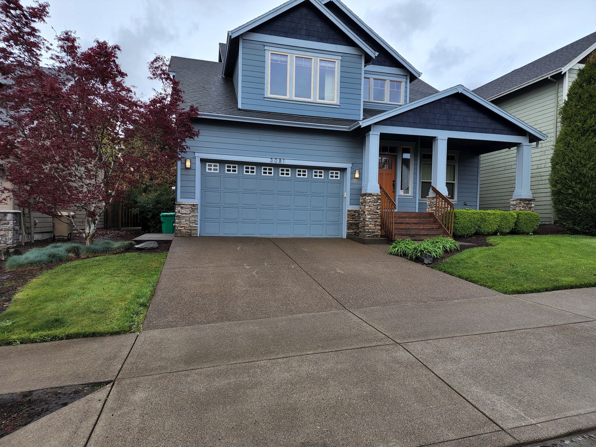 Hot water pressure washing removing mold from a home's exterior in Beaverton