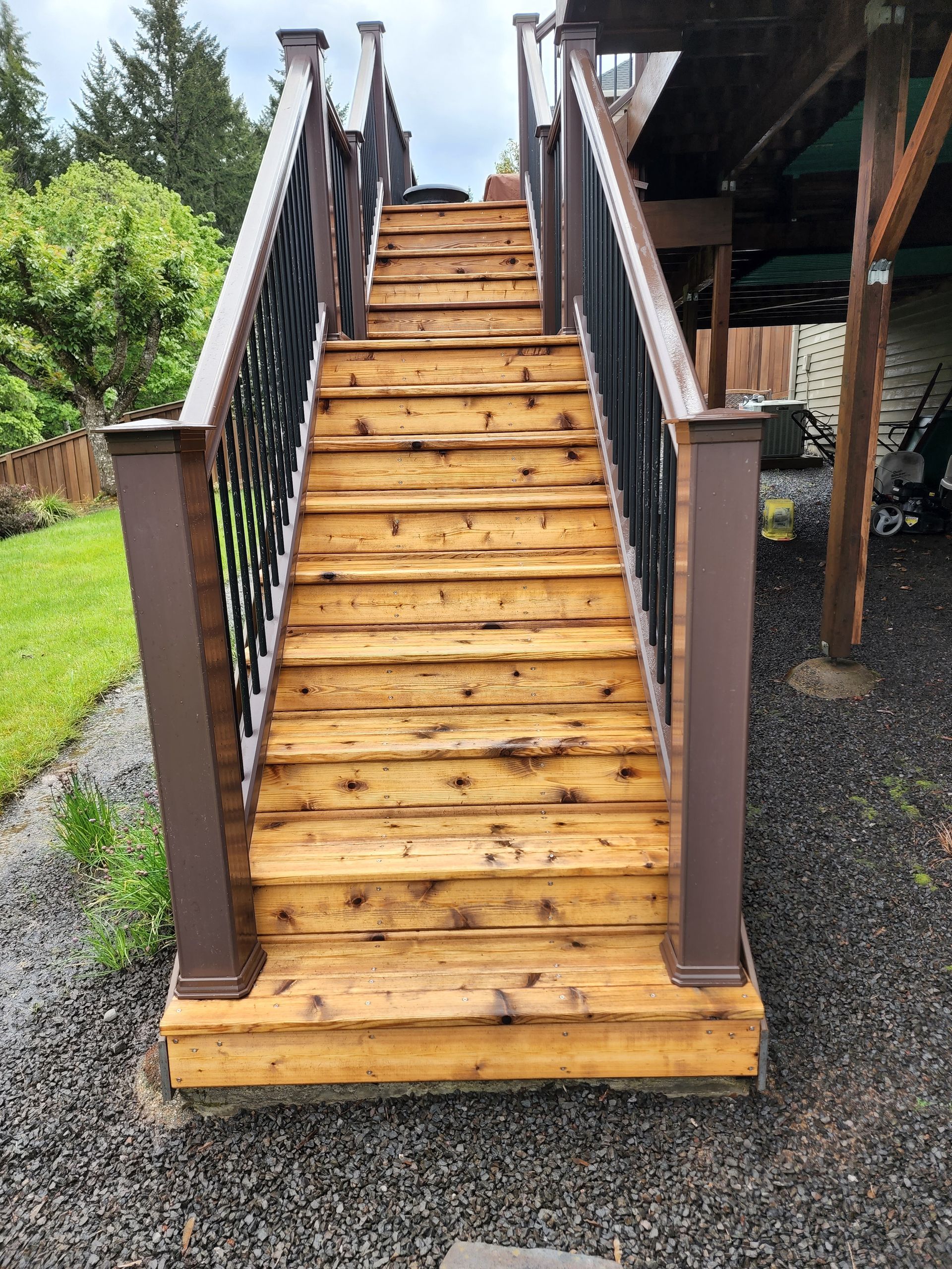 Low-pressure soft washing a home’s deck washing in Tigard, safely removing dirt and algae