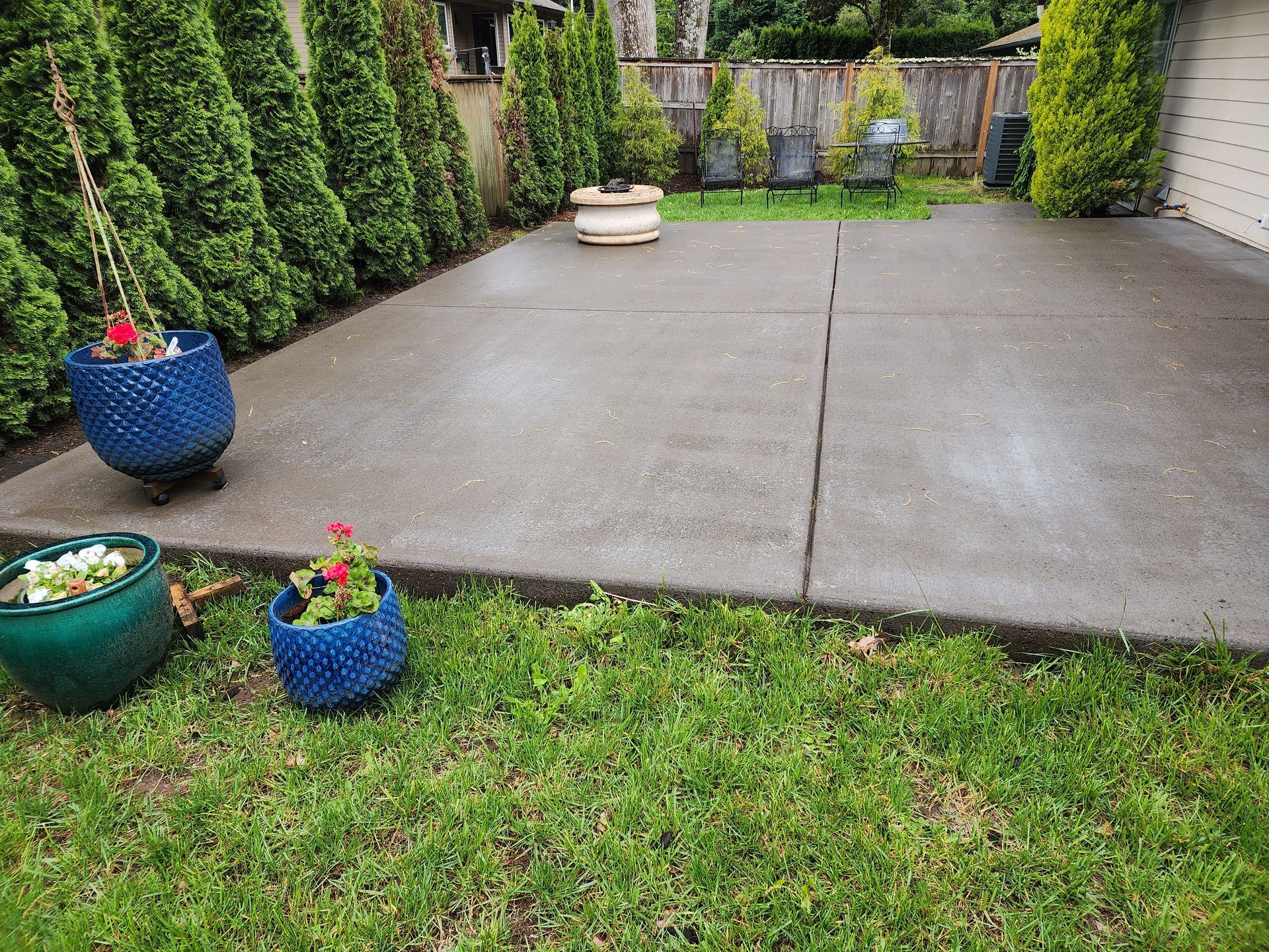 Hot water pressure washing removing mold from a home's Concrete in Tigard Oregon