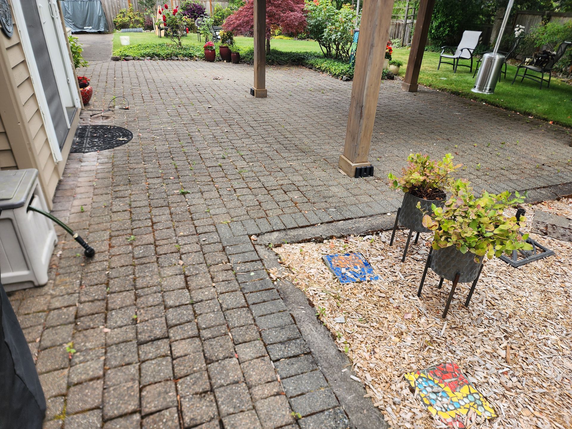 Low-pressure soft washing a home’s deck cleaning in Tigard, safely removing dirt and algae