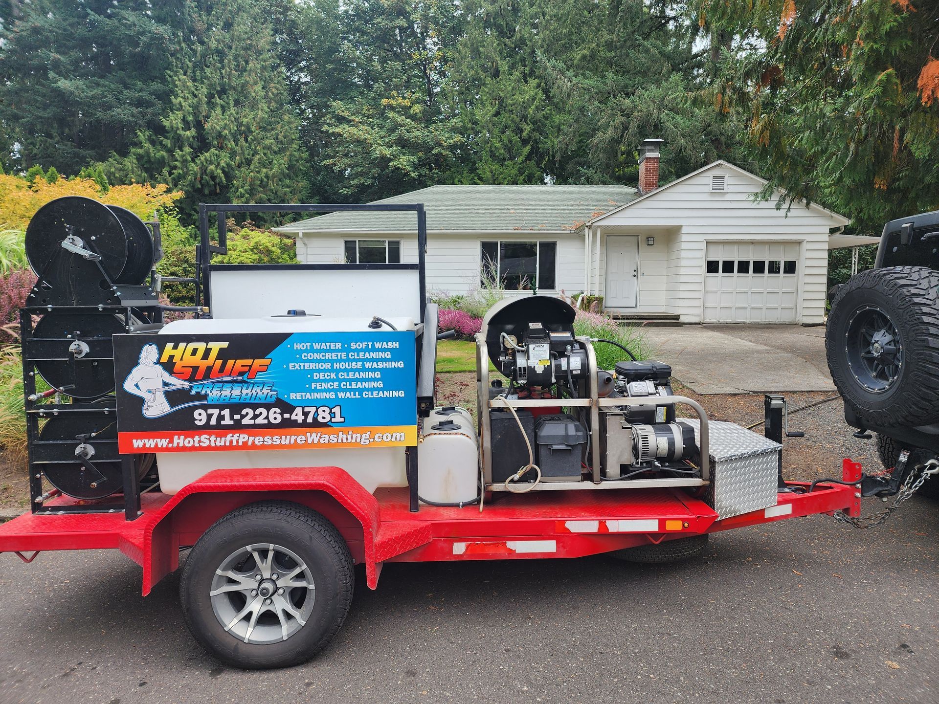 High-pressure hot water cleaning a concrete driveway, removing dirt and grime in Tigard Oregon