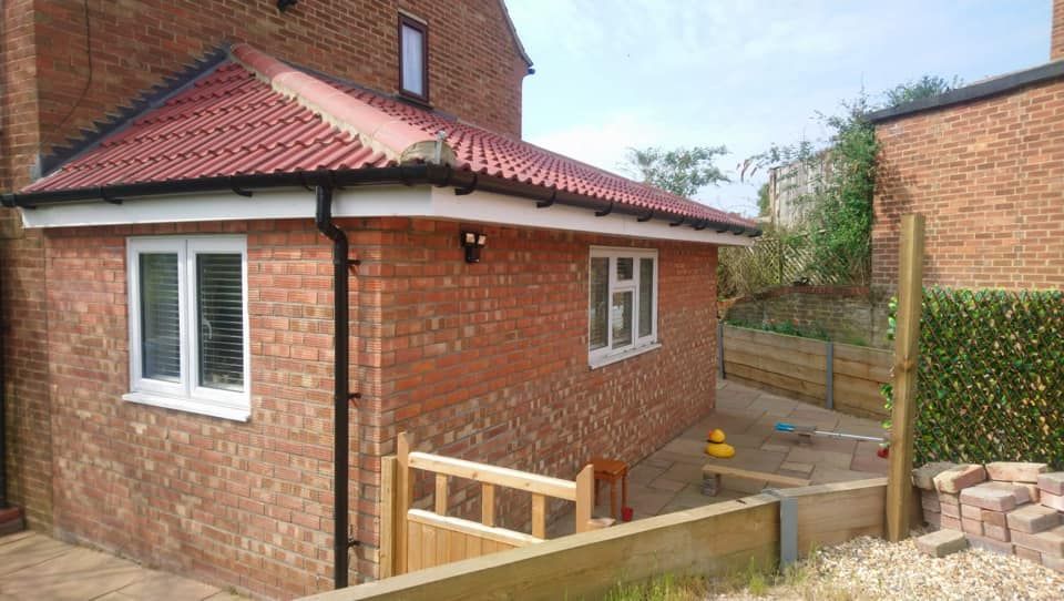 A beautiful rear single storey extension with a patio and gate, built by Pro Build East Ltd.