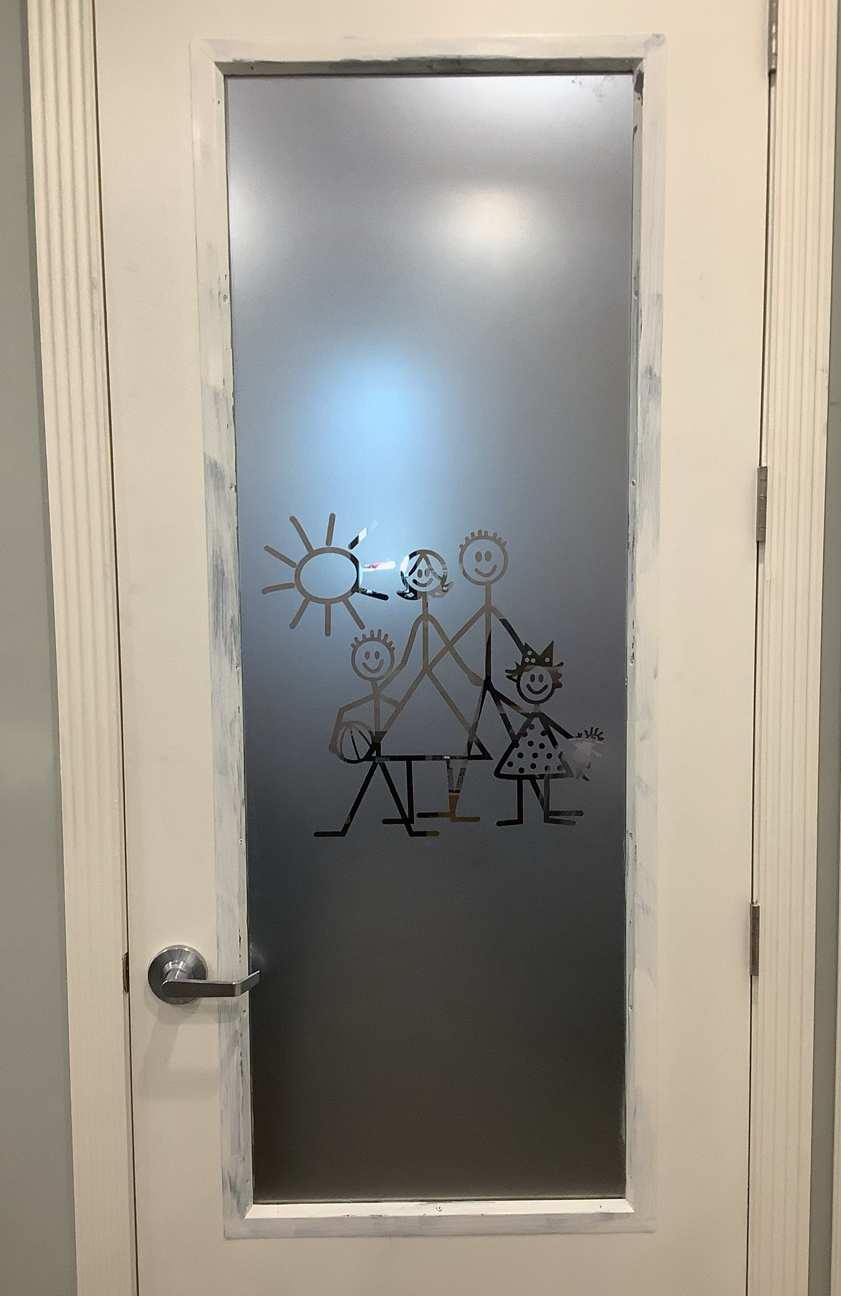 A door with a drawing of a family on it
