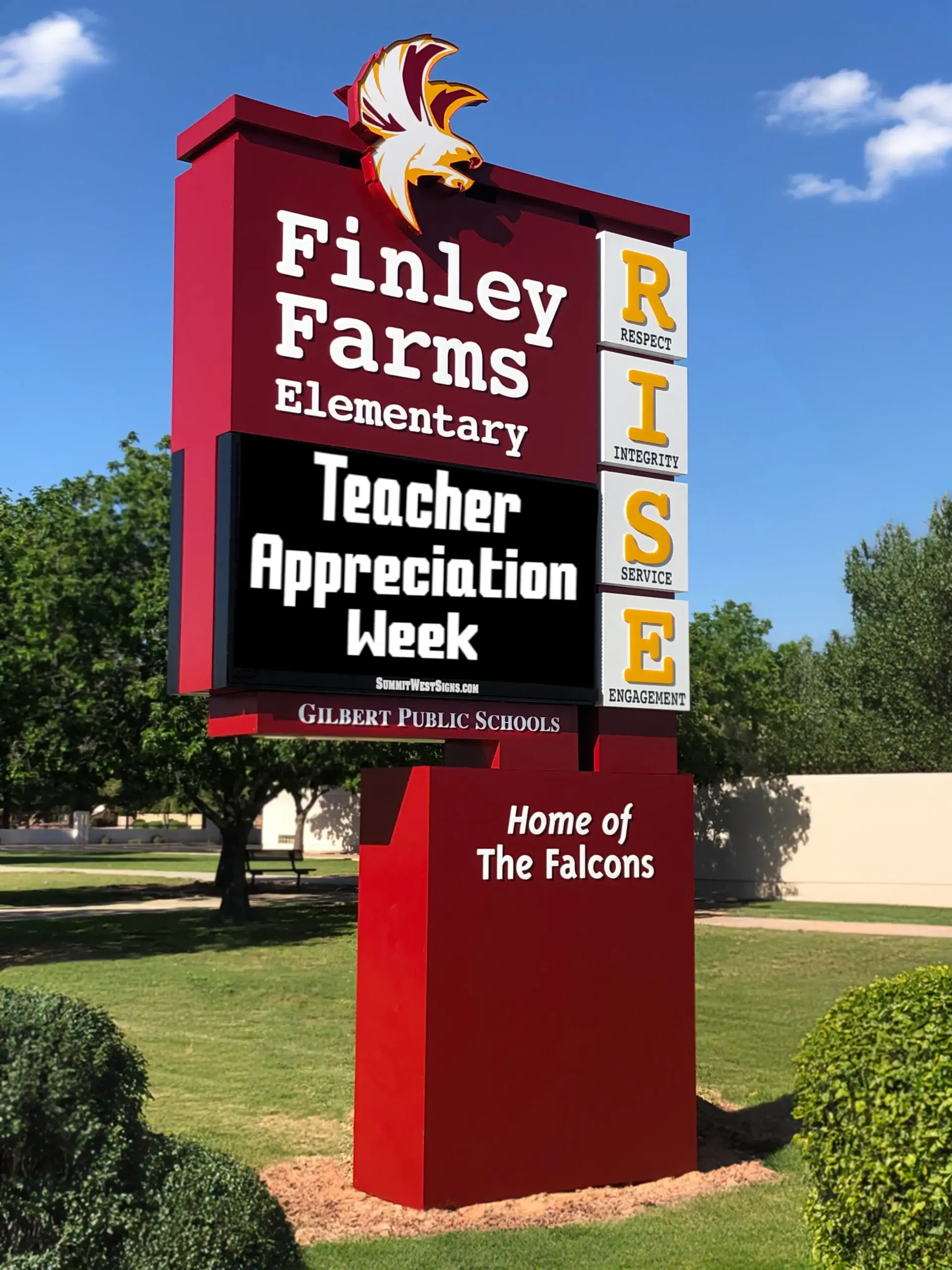 A large red sign for finley farms elementary school