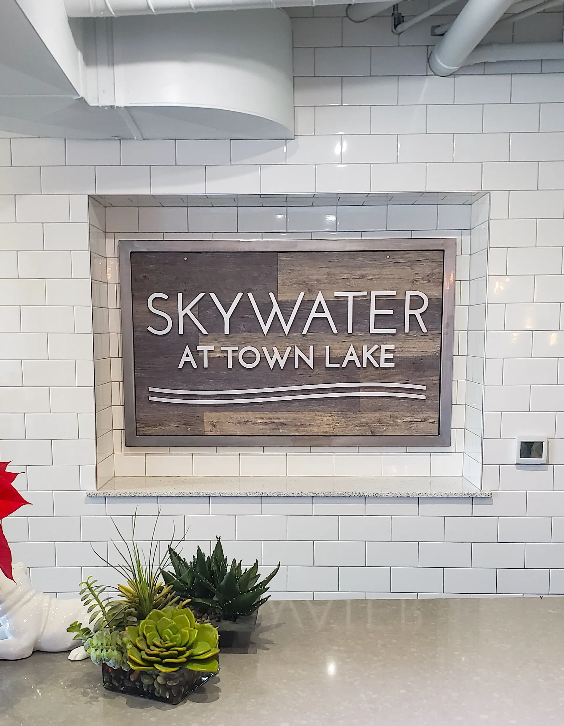 A sign on a wall that says skywater at town lake