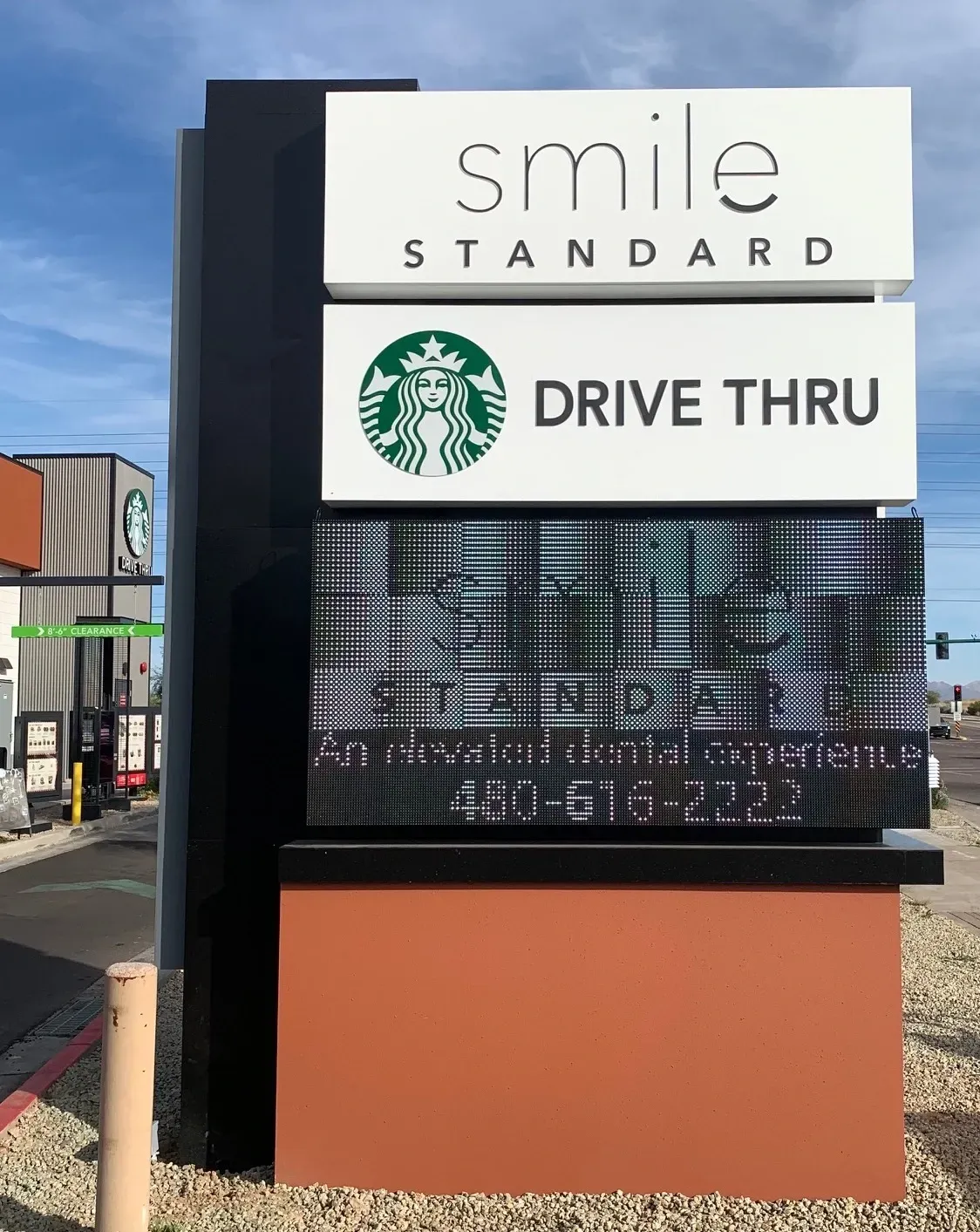 A starbucks drive thru sign with a starbucks logo on it.