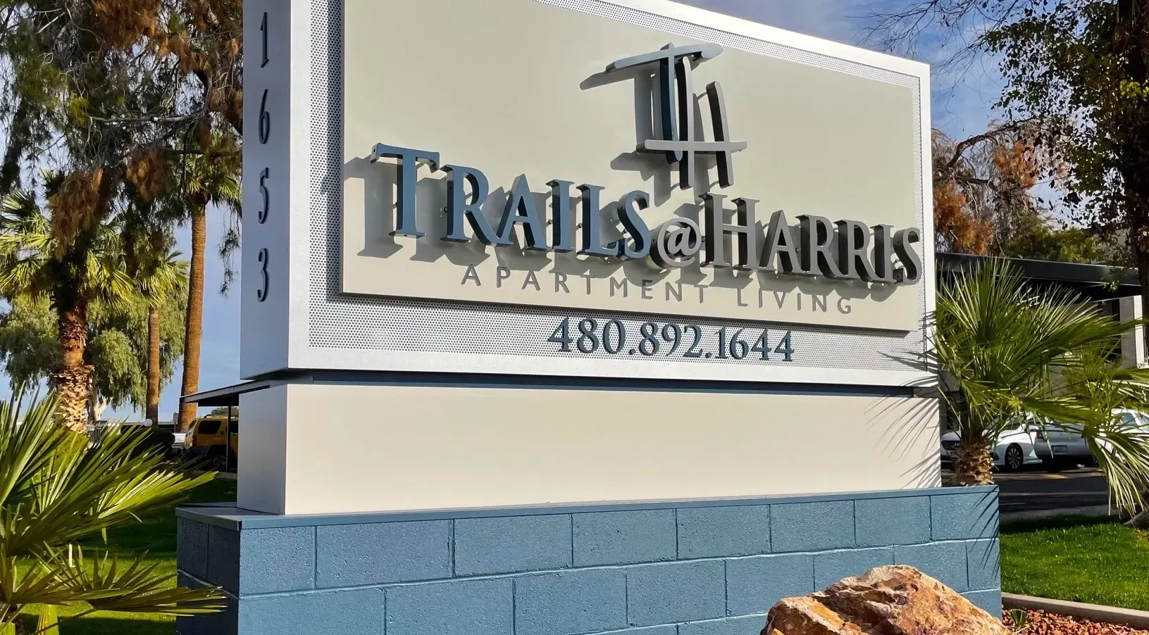 A sign for trails & harris apartment living