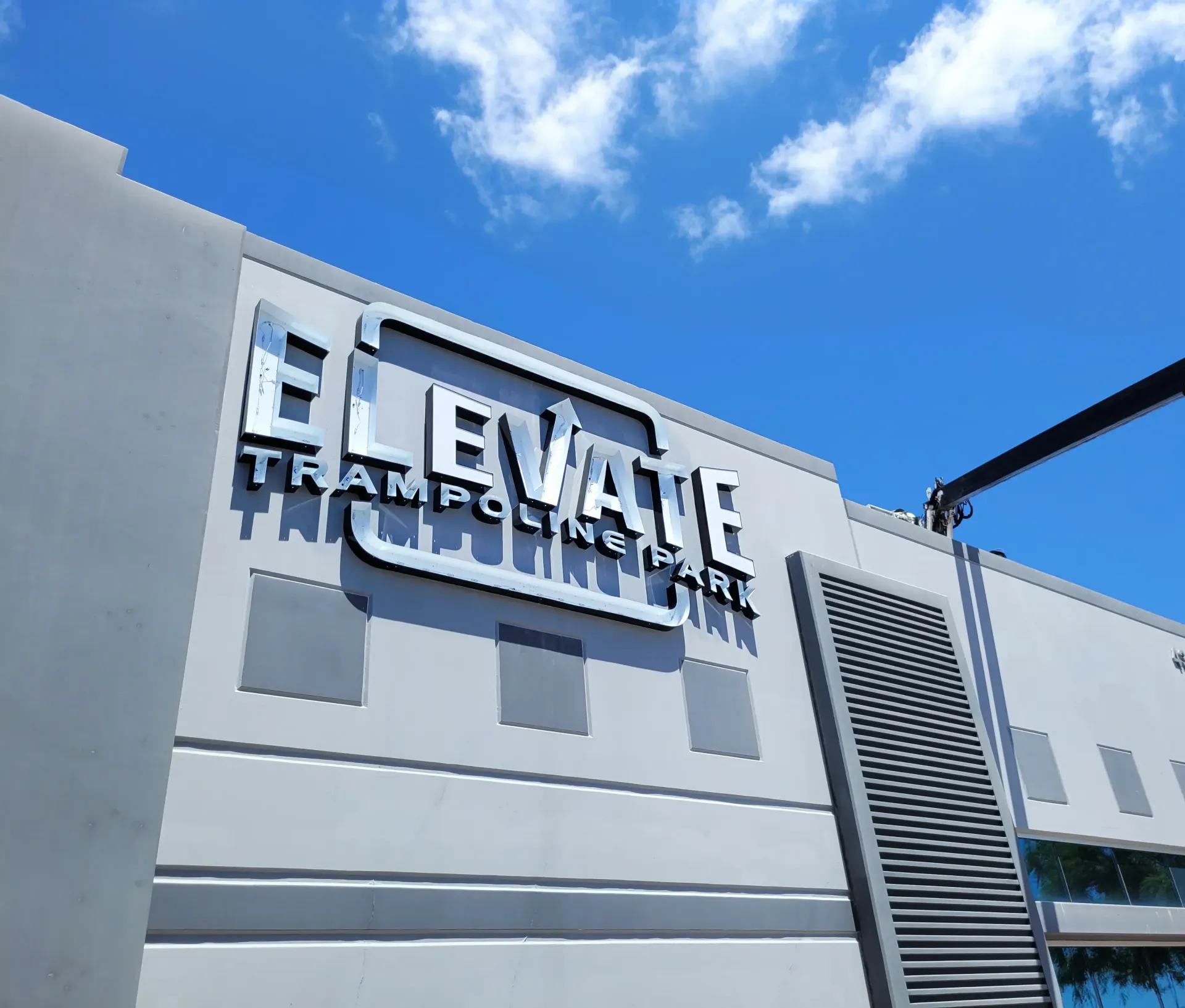 A building with a sign that says elevate trampoline park