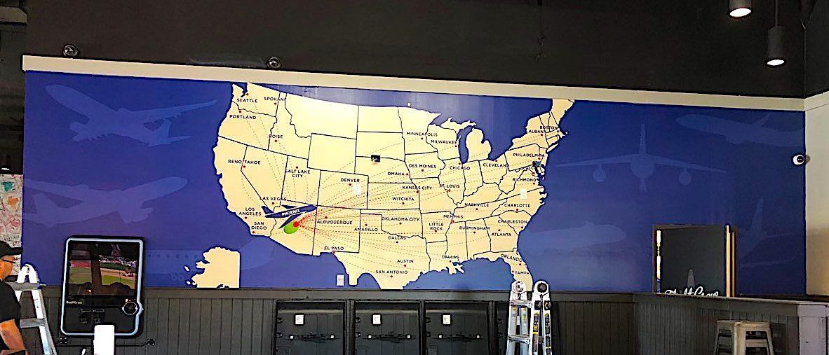 There is a large map of the united states on the wall.