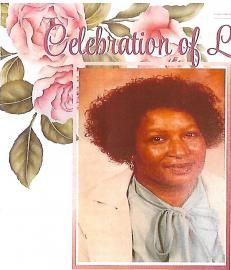 Memorial tribute card with floral border and a portrait of a woman in a light blue blouse