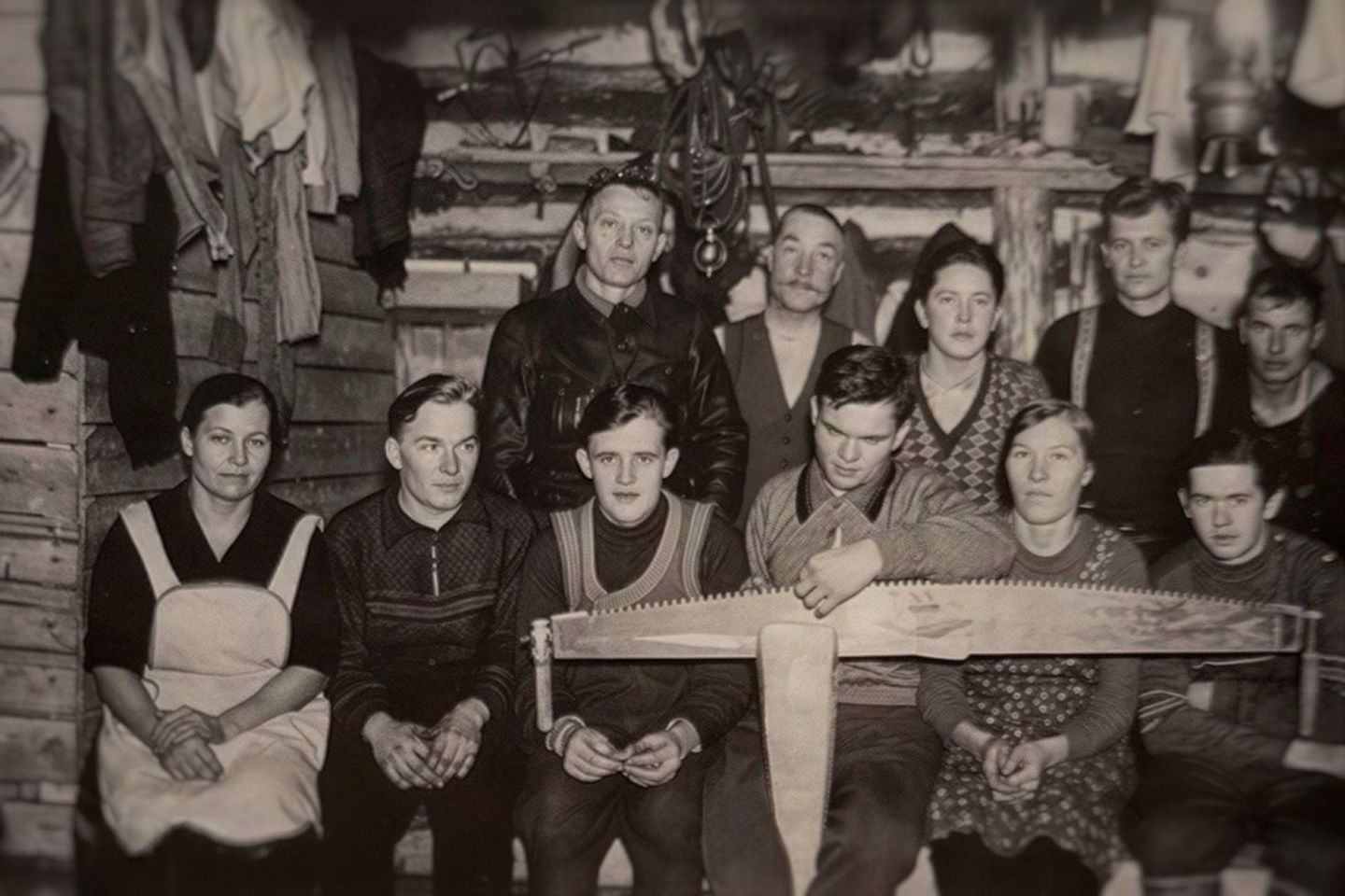 Arctic GM family and community members gathered around a traditional tool