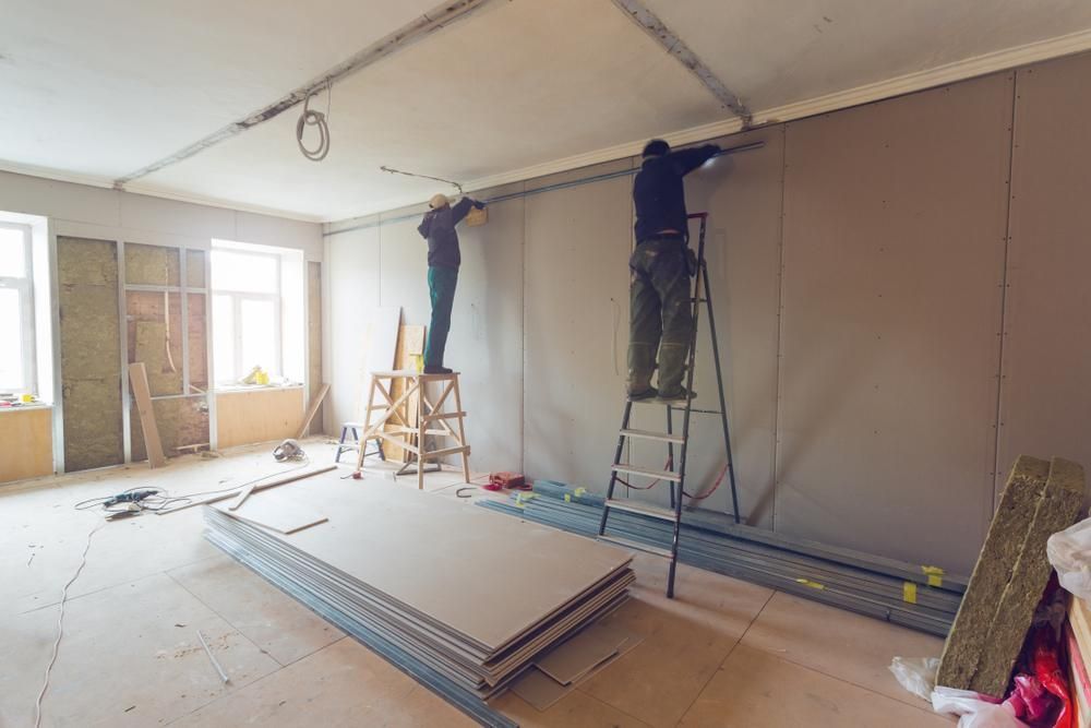 Two Men Are Working On A Wall In A Room — Canberra Handyman Solutions In Wanniassa, ACT