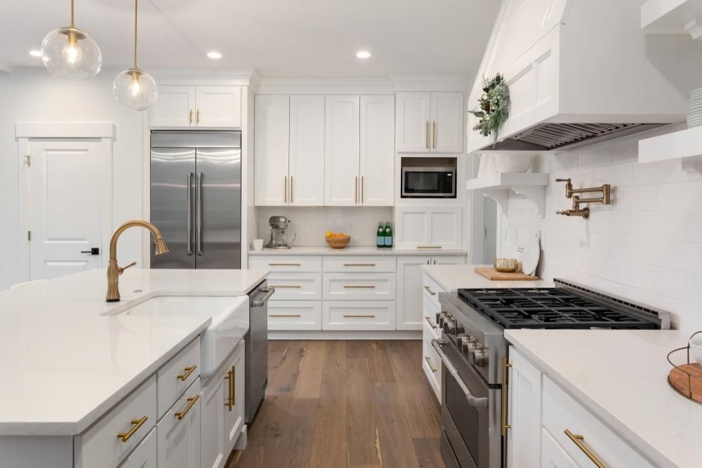 A Kitchen With White Cabinets And Stainless Steel Appliances — Canberra Handyman Solutions In Wanniassa, ACT