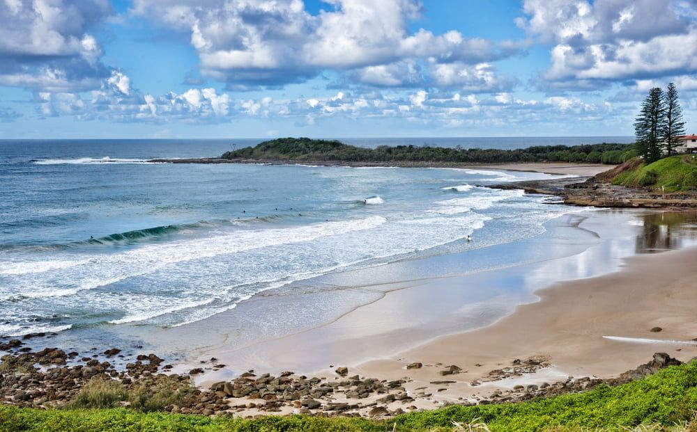 A Beach with Waves Crashing on The Shore on A Sunny Day — Stihl Shop Grafton in Yamba, NSW
