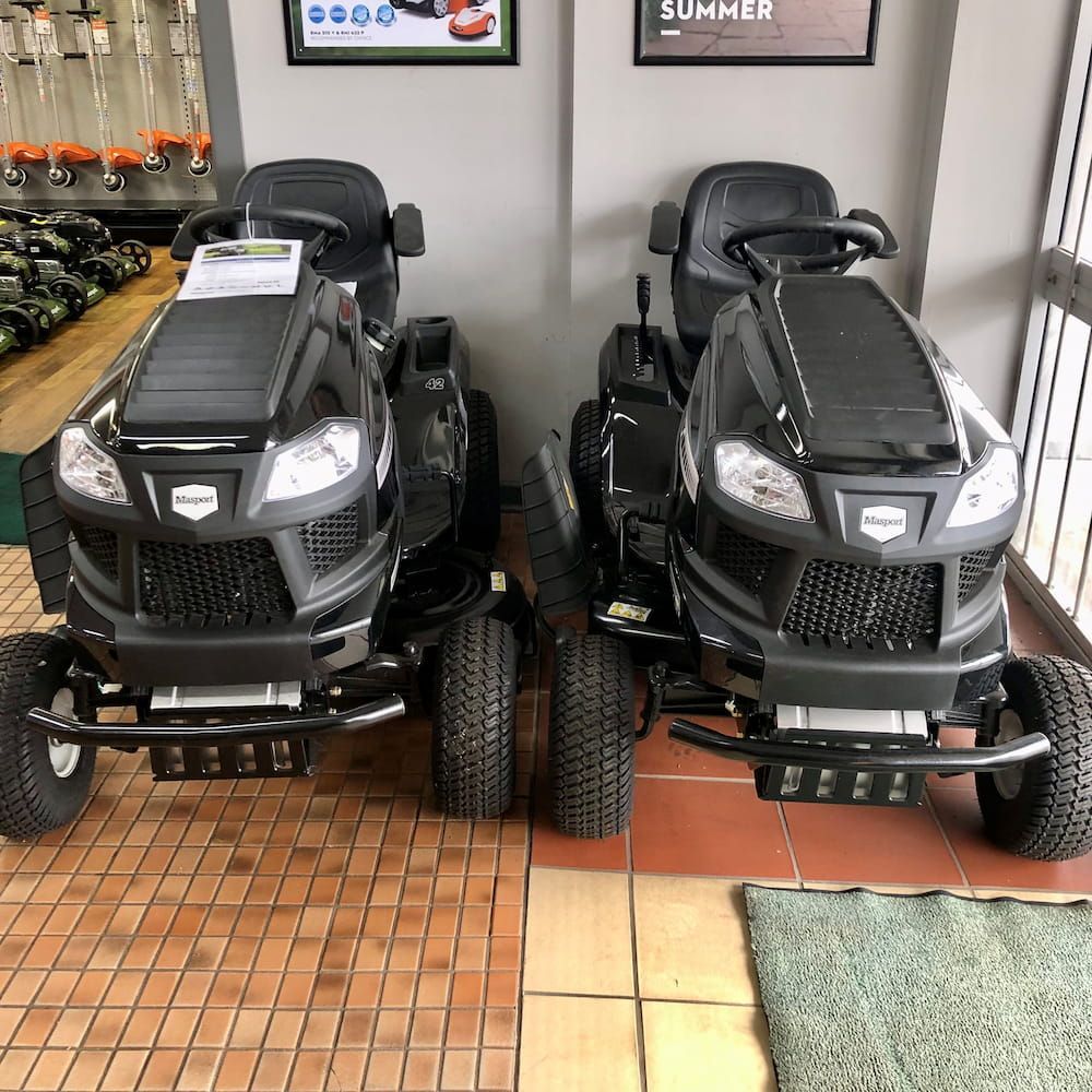 Two Black Lawn Mowers Are Parked Next to Each Other in A Showroom — Stihl Shop Grafton in Grafton, NSW