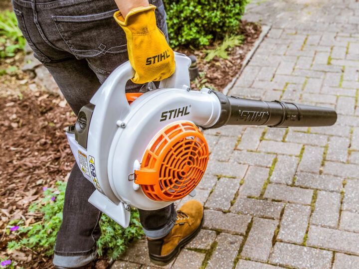 A Person Is Holding a Stihl Blower on A Sidewalk — Stihl Shop Grafton in Grafton, NSW