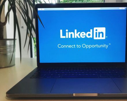 A laptop with the linkedin logo on the screen
