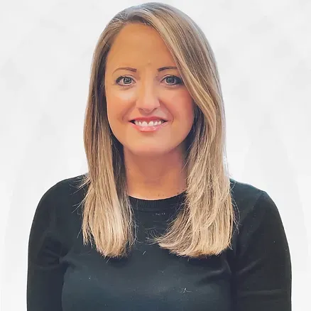 A woman with long blonde hair is wearing a black shirt and smiling.