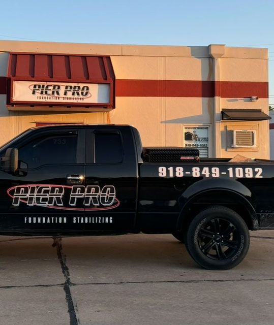 Black truck with "Pier Pro Foundation Stabilizing" parked outside a building. Phone number visible: 918-849-1092.