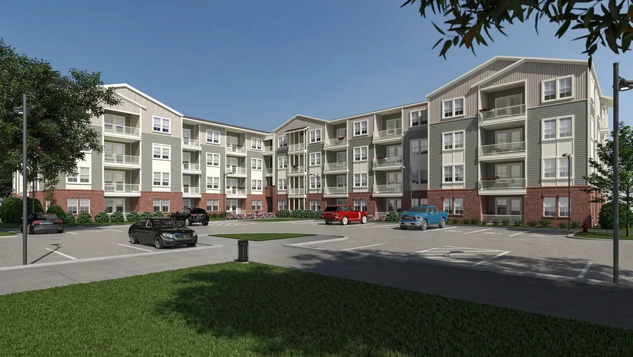 Exterior view of a modern apartment building with a parking lot and trees.