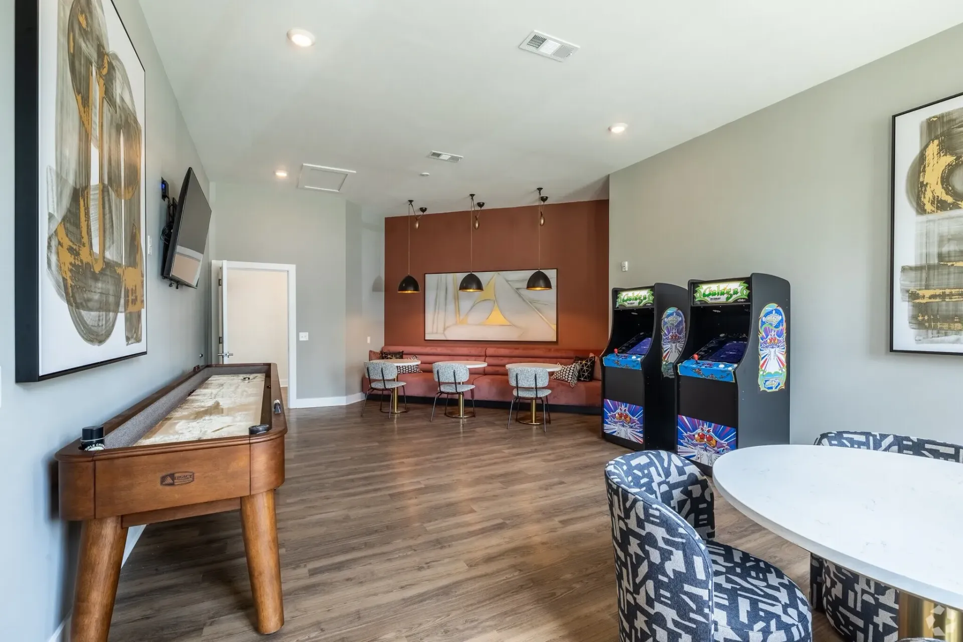 Recreation room with shuffleboard and arcade games.