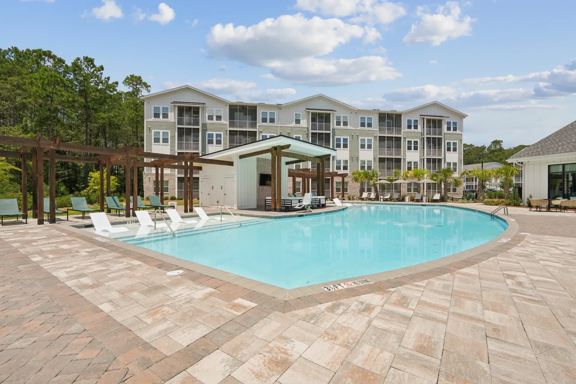 Outdoor swimming pool with lounge chairs and cabana